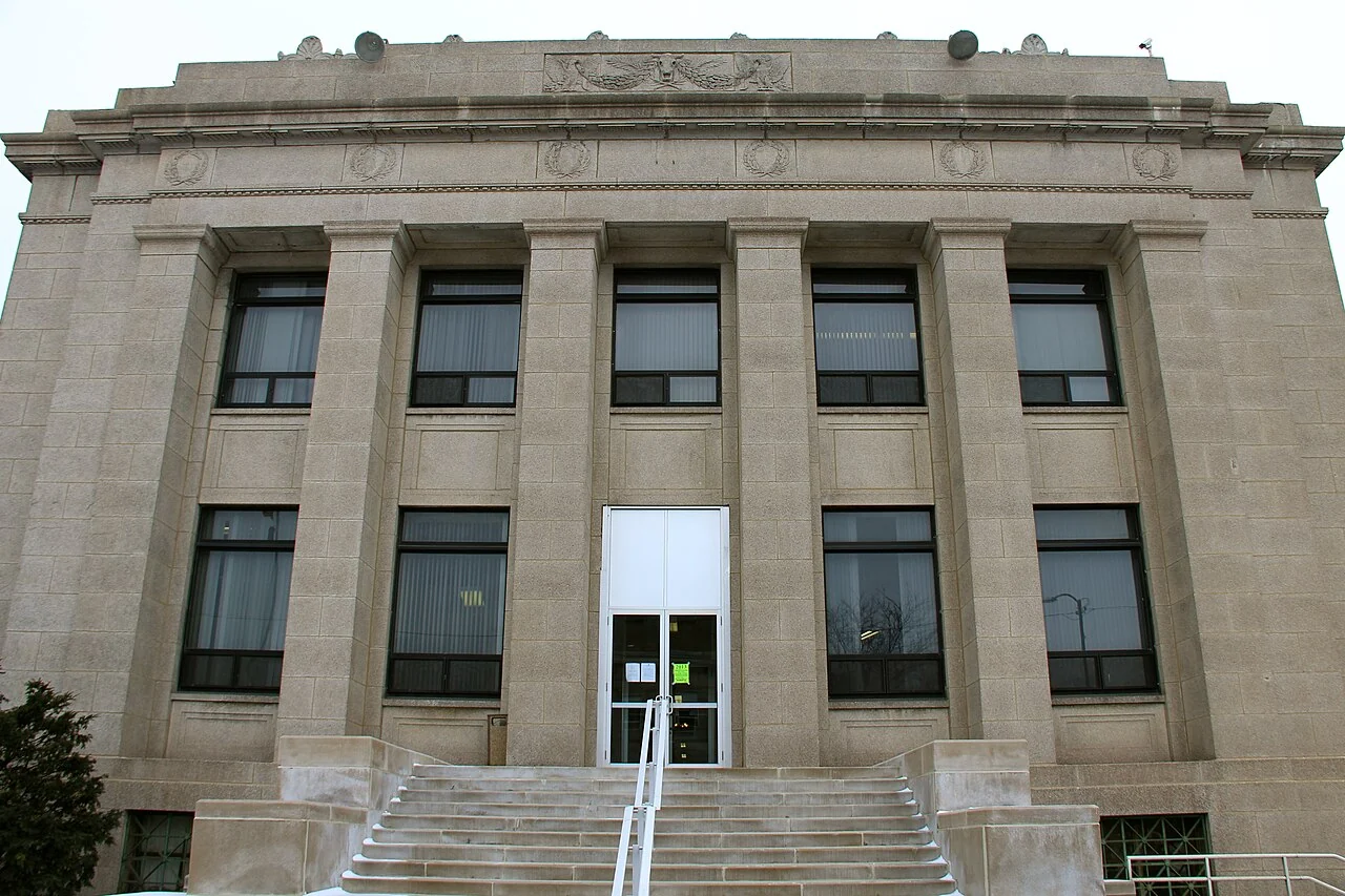 The stone columns, entrance steps, and front doors of Gary City Hall.