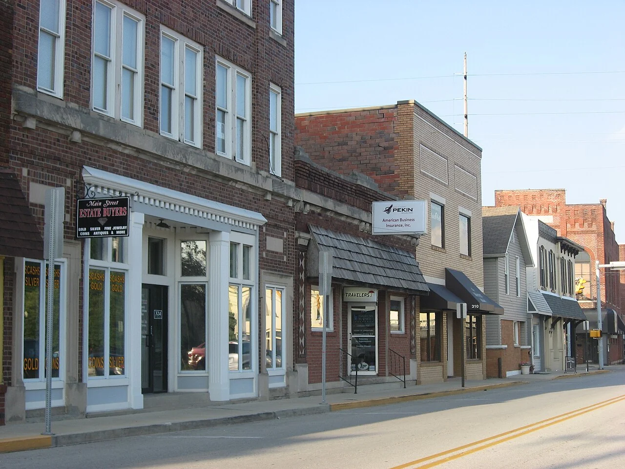 A row of brick storefronts along West Main Street in the Greenwood Commercial Historic District.