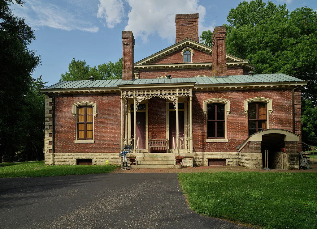 The brick main house and covered porch at Ashland in Lexington.