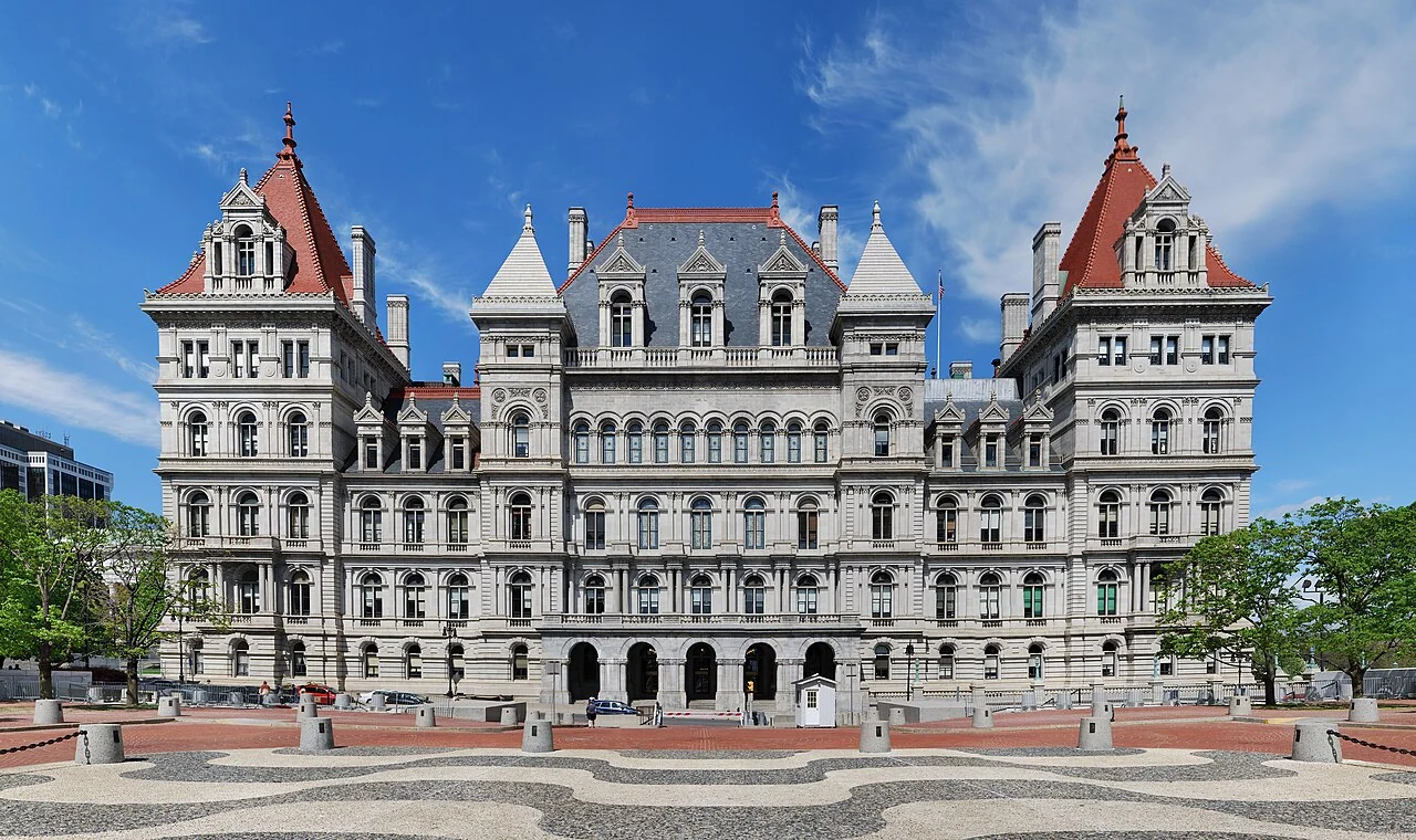 The ornate stone facade and red-roofed towers of the New York State Capitol in Albany.