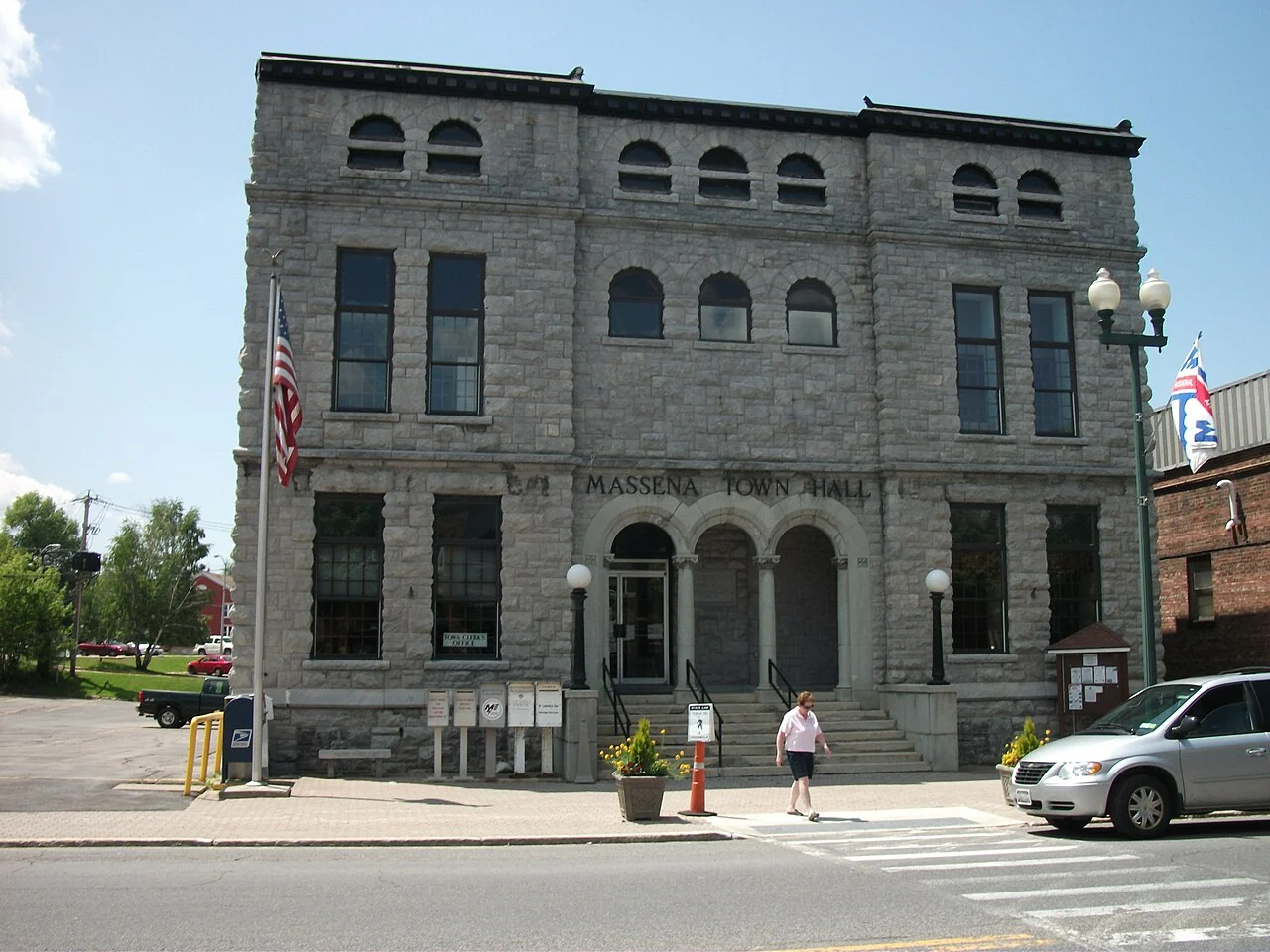 The historic stone facade of Massena Town Hall on Main Street.