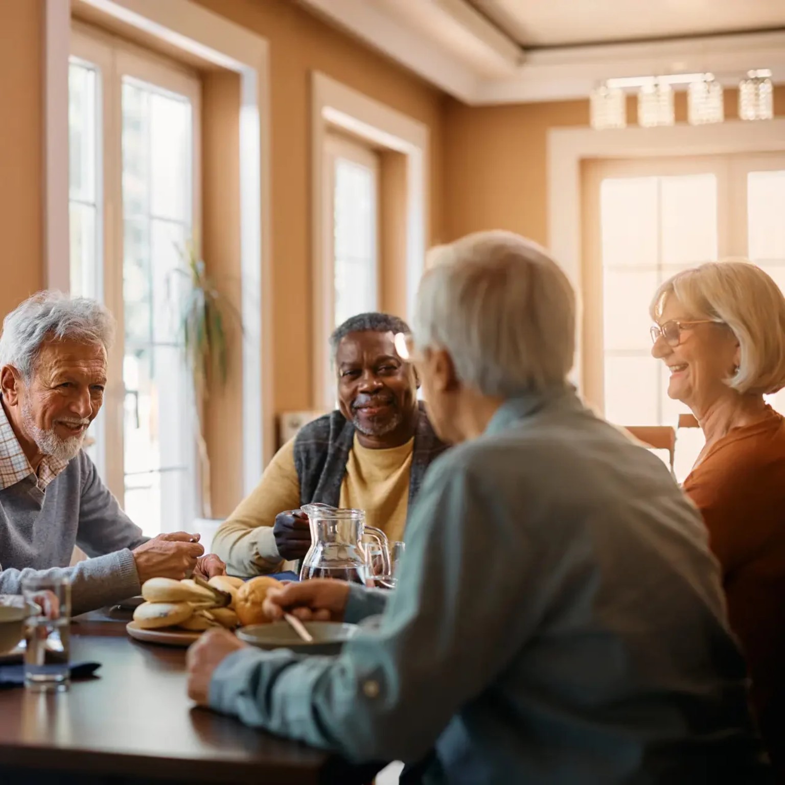 Older adults sharing a meal and conversation around a table